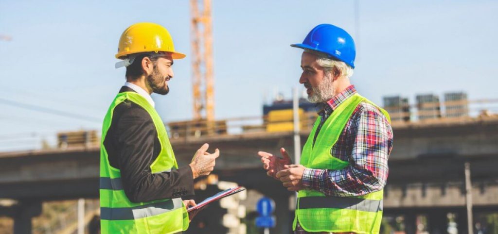 Two Construction Workers Discussing Picture Id629606438 1200x565 1 1 1024x482